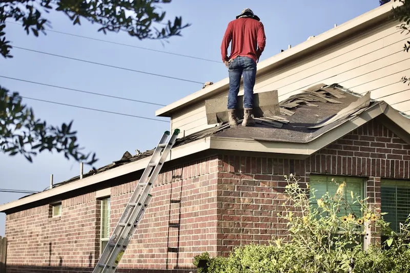 Professional roofer working on a residential roof in Landmark Ranch Estates